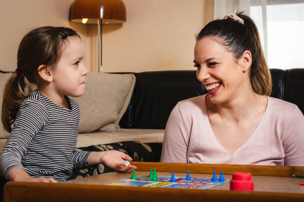istock Family playing board game at home. 1203214599