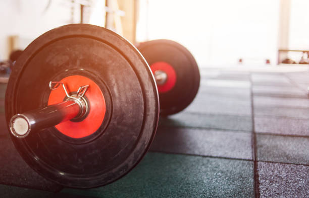 istock Closeup barbell on the gym floor 1203216213