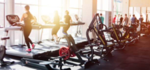 Blurred photo of a gym with people on treadmills Blurred photo of a gym with people on treadmills gym photos stock pictures, royalty-free photos & images