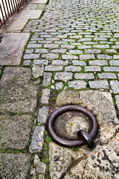 istock Old large rusty metal ring for mooring boats in the river 1203216253