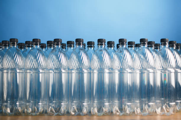 empty plastic bottles on blue background empty plastic bottles on blue background, close-up view polyethylene terephthalate stock pictures, royalty-free photos & images