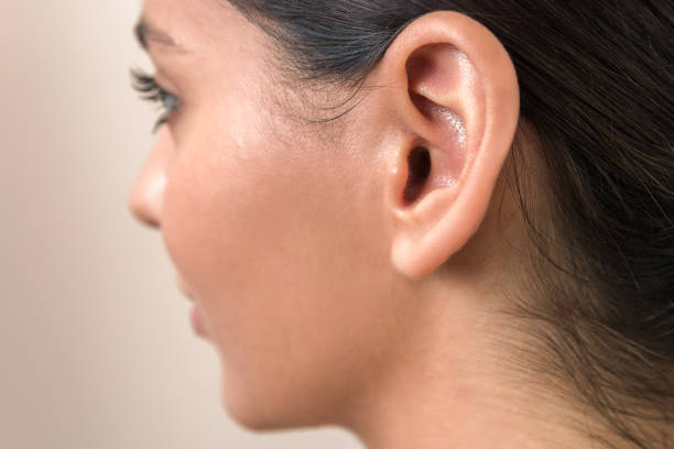 hearing problems. close up ear of a young woman. women hear everything hearing problems. close up ear of a young woman. women hear everything. Earlobe stock pictures, royalty-free photos & images