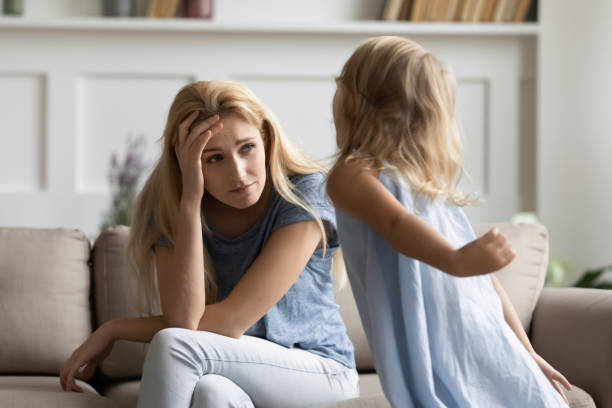 istock Stressed young woman irritated by loud hyperactive little preschool kid. 1203220221