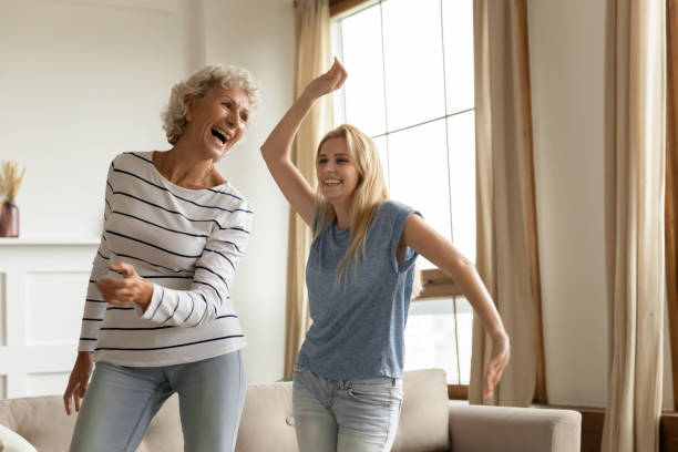 istock Laughing sincere elderly mother having fun grown up daughter. 1203220281