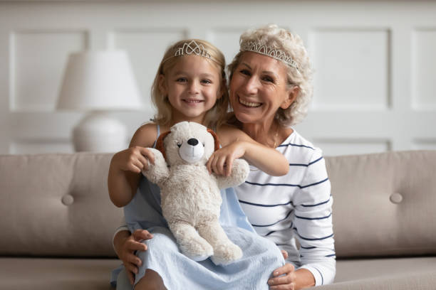 istock Different generations female family wearing crowns, portrait. 1203220287