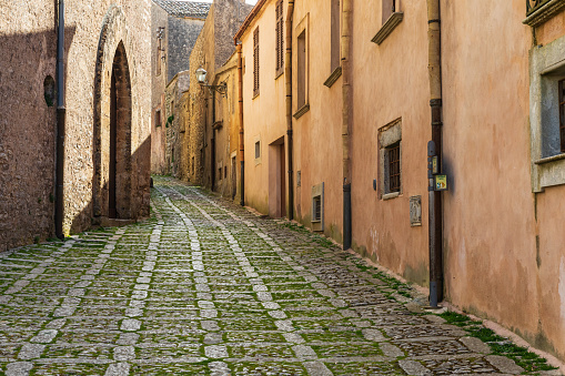 Italy, Sicily, Trapani Province, Erice. A narrow cobblestone street in the ancient hill town of Erice.