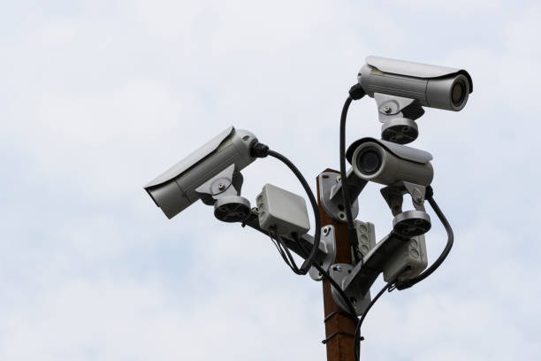 istock A group of surveillance cameras on a sky background. 1203224898