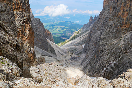 Sassolungo - Saslonch (Langkofelrunde) gap in the Dolomites mountains, Italy, with layers of scree, as seen from a circular hiking tour, in the Summer.