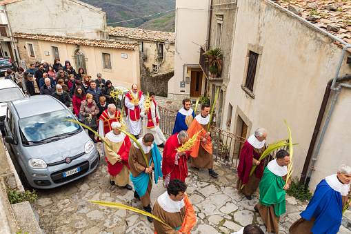 Italy, Sicily, Messina Province, Montalbano Elicona. April 14, 2019. Parishioners parade to the parish church for Palm Sunday services in Montalbano Elicona.