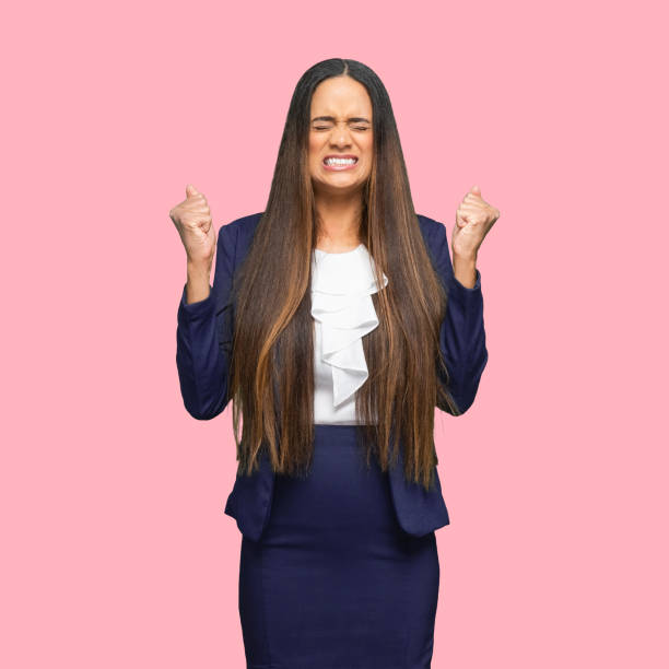 African-american ethnicity female manager standing in front of colored background wearing skirt Portrait of aged 30-39 years old who is beautiful with long hair african-american ethnicity female manager standing in front of colored background wearing skirt who is paranoia embarrassment skirt photos stock pictures, royalty-free photos & images