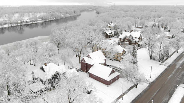 Serene neighborhood covered with snow, homes blanketed in white.