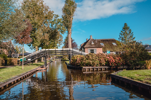 Giethoorn, Netherlands - November 9, 2019: Giethoorn is a town in the province of Overijssel, Netherlands with a population of 2,620. It is located in the municipality of Steenwijkerland, about 5 km southwest of Steenwijk. As a popular Dutch tourist destination both within Netherlands and abroad, Giethoorn is often referred to as \