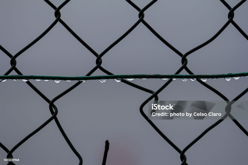 chain link fence chain link fence with with raindrops Abstract Stock Photo
