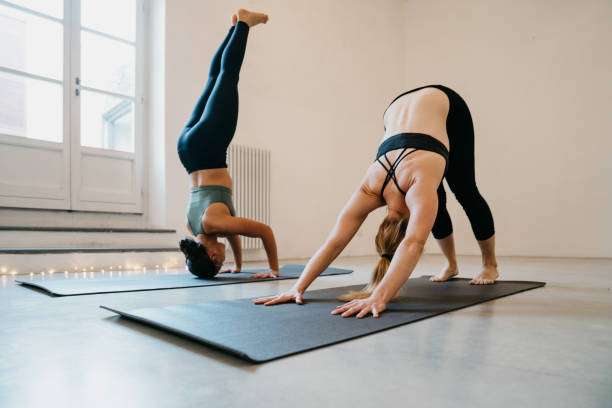 istock Two women are practicing yoga together 1203232010
