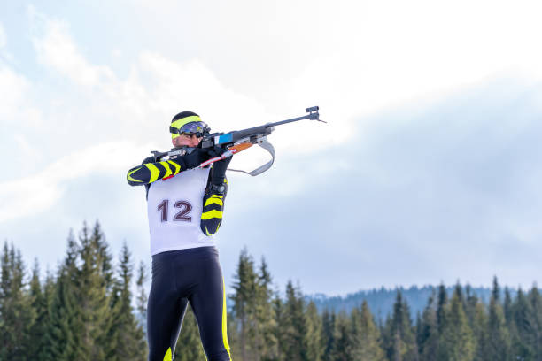 istock Biathlete holds his breath while shooting the rifle in a standing position during the biathlon race 1203232637