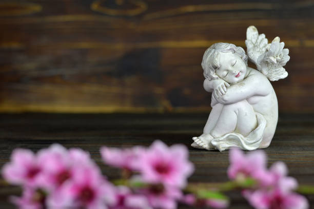 istock Guardian angel on wooden background 1203233234