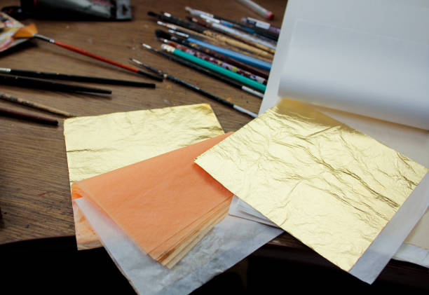 istock Gold Leaf. A lot of square gold leaf in studio of painter. 1203233369
