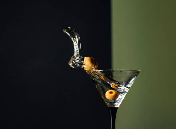 istock Martini with green olives splash. 1203233584