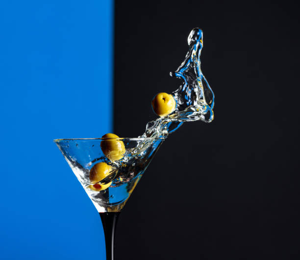 istock Martini with green olives splash. 1203233596