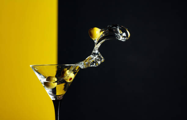 istock Martini with green olives splash. 1203233601