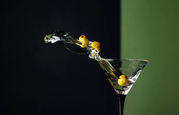 istock Martini with green olives splash. 1203233613