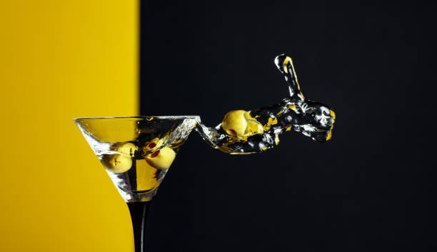 istock Martini with green olives splash. 1203233620