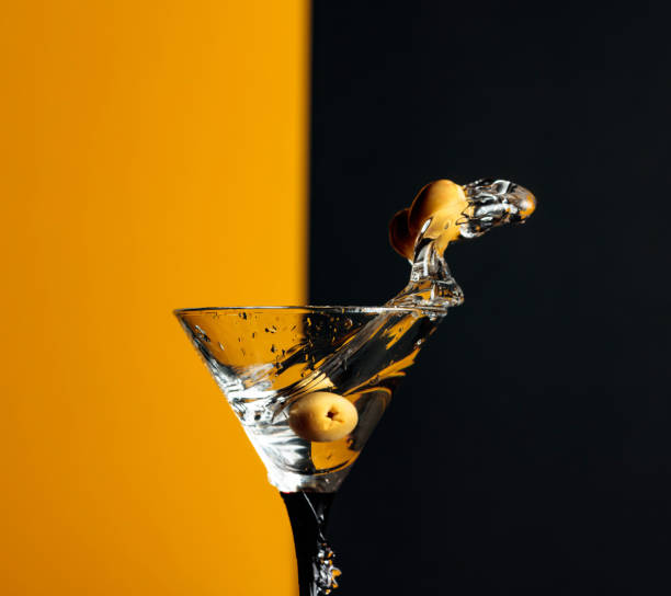 istock Martini with green olives splash. 1203233631