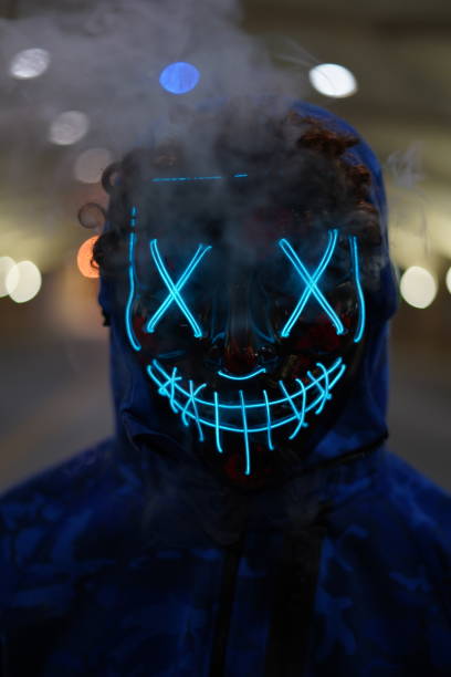 istock Halloween mask with smoke and blue lights 1203234799
