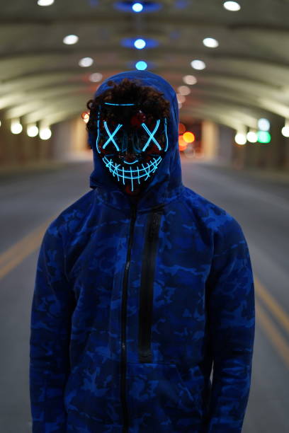 istock Man in mask standing in a city 1203234810