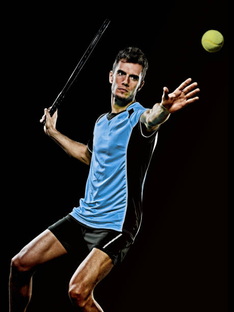 istock caucasian young tennis player man isolated black background 1203235351
