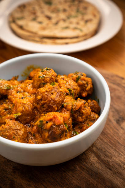 istock Potato curry with chapatti (roti) placed on wooden table. 1203237907