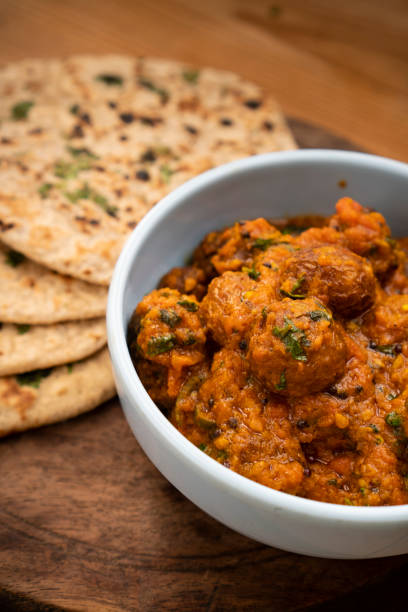 istock Potato curry with chapatti (roti) placed on wooden table. 1203238053