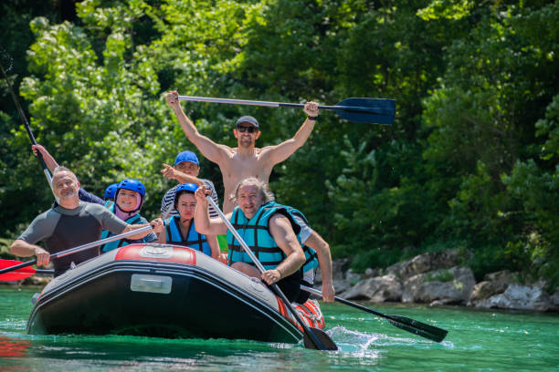 istock Rafting team goes down the river on the beautiful sunny day. Celebrating. 1203238911