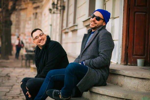 istock Cheerful male speaking with outgoing comrade outside 1203239104