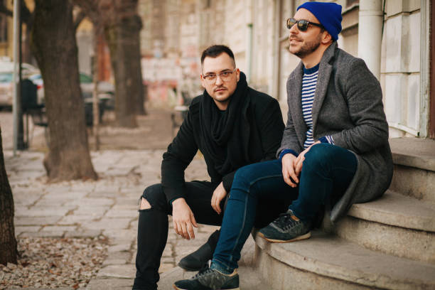 istock Cheerful male speaking with outgoing comrade outside 1203239194