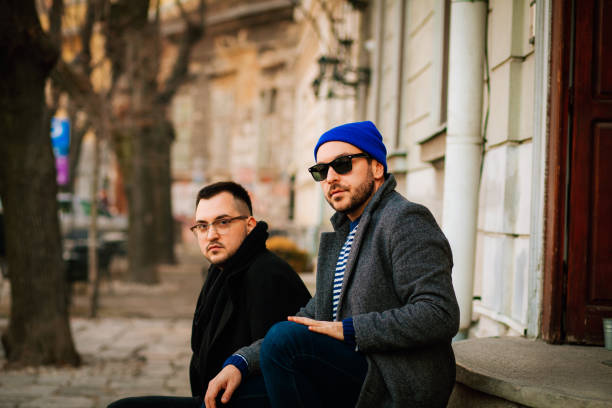istock Cheerful male speaking with outgoing comrade outside 1203239231