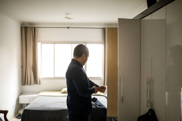 istock Business man getting dressed to go to work 1203239615
