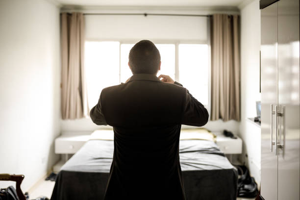 Businessman putting on his blazer jacket