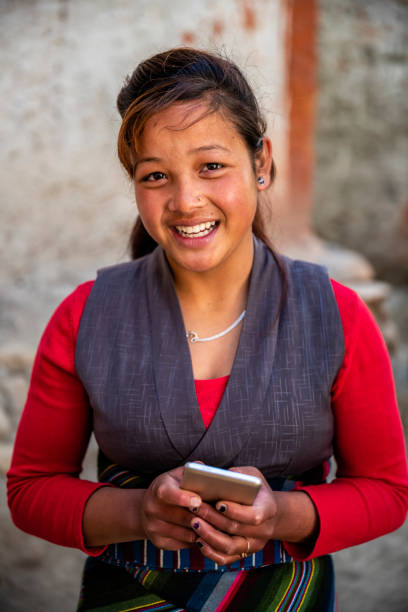 istock Tibetan young woman using mobile phone, Upper Mustang, Nepal 1203240774