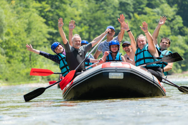 istock Rafting team goes down the river on the beautiful sunny day. Celebrating. 1203241122