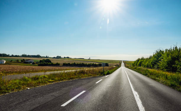istock Empty long road on a sunny summer day at bright sunset 1203242069