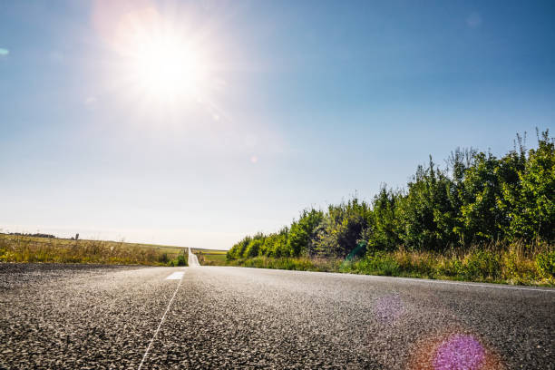 istock Empty long road on a sunny summer day at bright sunset 1203242117