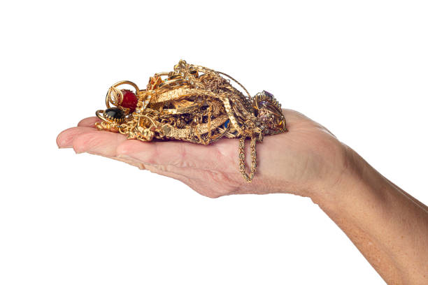 istock Hand Holding Gold Jewelry Isolated On White 1203244669
