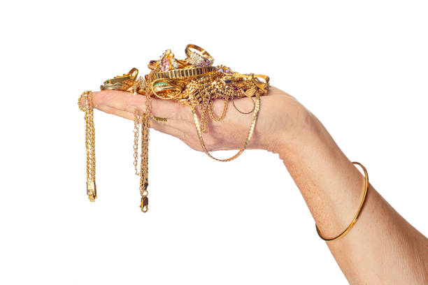 Hand Holding Gold Jewelry stock photo