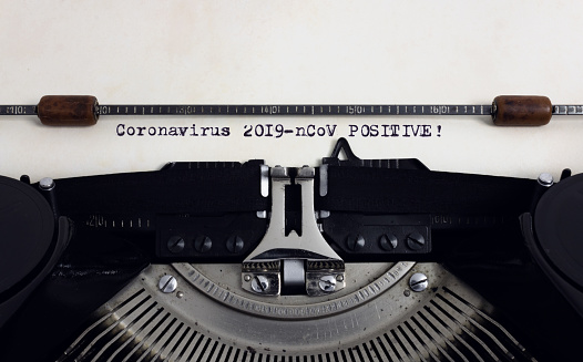 Old retro vintage typewriter with typed heading Coronavirus 2019-nCov Positive
