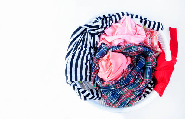 istock a pile of colorful clothes on white background 1203247371