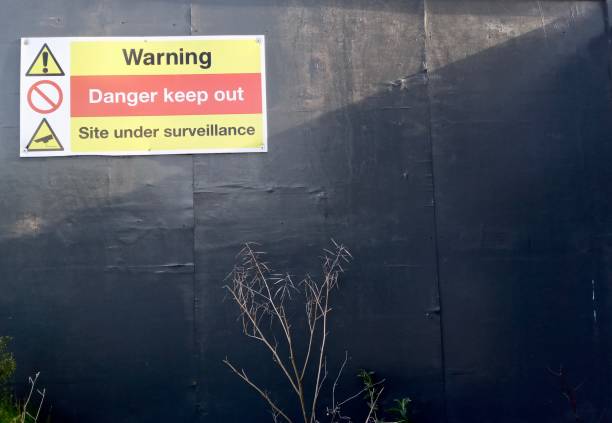 istock Yellow red and black warning sign medium shot by construction site 1203248488