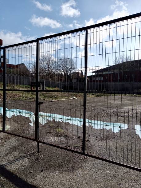istock Gate of construction site in UK 1203248918