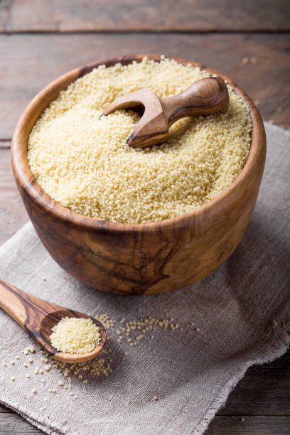istock Raw Couscous in a wooden bowl on the table 1203251930