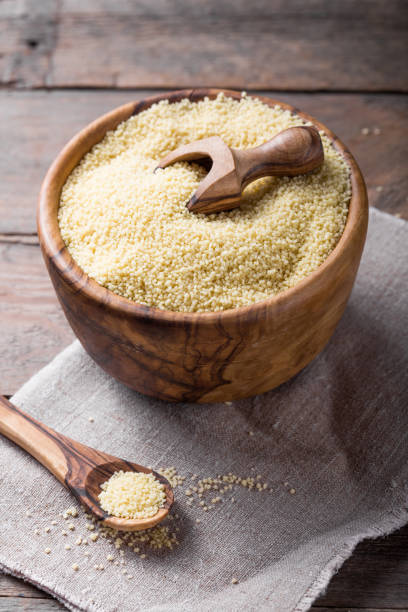 istock Raw Couscous in a wooden bowl on the table 1203251938